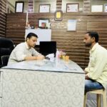 Dr. Vishad Patel best laparoscopic surgeon in Jaunpur talking to his patient about importance of health check ups.