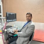 Top Pathologist in Jaunpur Dr. Lalji Patel, top pathologist in Jaunpur sitting in his cabin.