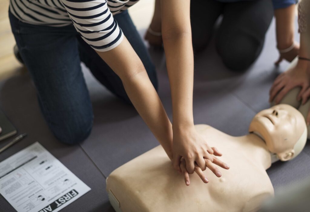 a man giving cpr as first aid to a dummy.First aid tips for common household injuries
